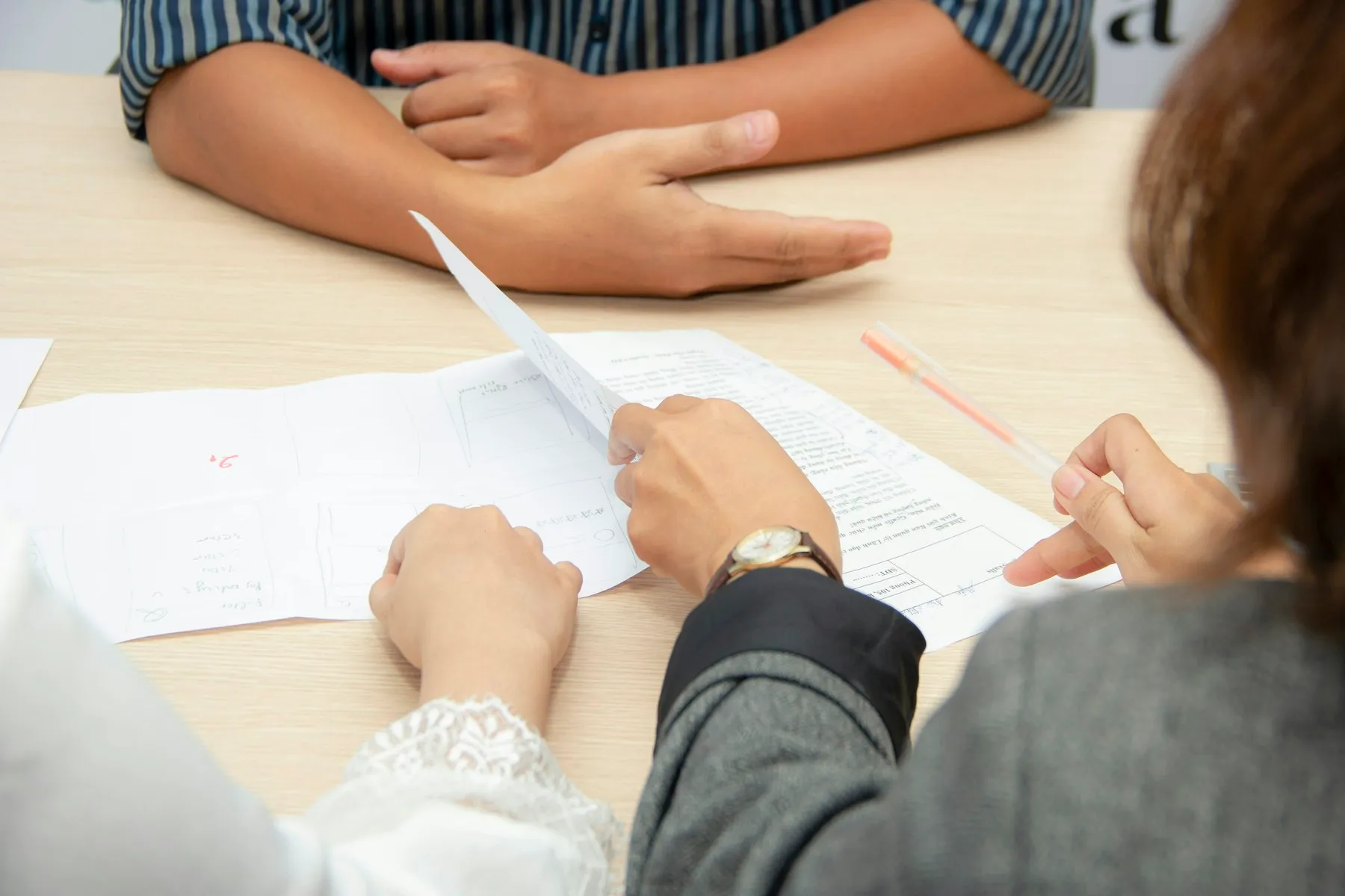 Two people talking across a table during a meeting