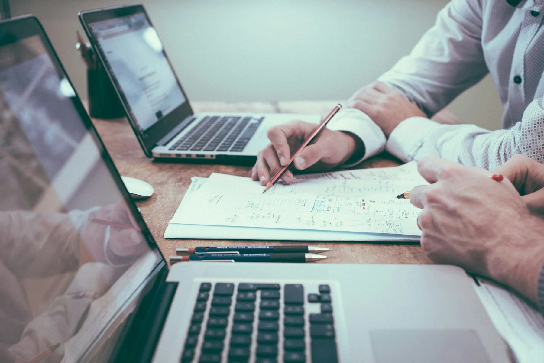 Two people reviewing a document together at a desk
